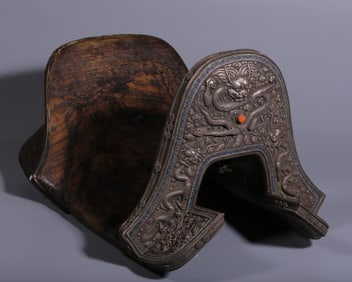 A Qing Dynasty silver-burnt blue carved dragon spitting bead-patterned saddle