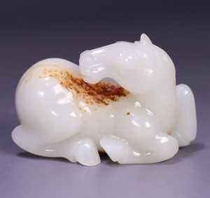 A Qing Dynasty Hetian jade reclining horse carving