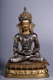 A seated statue of a longevity Buddha in the Qing Dynasty with copper gilt and silver inlaid