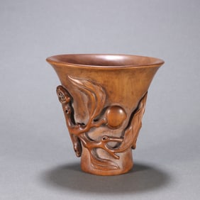 A Qing Dynasty boxwood carved longevity peach pattern cup