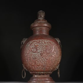 A bronze tired dragon playing bead double earring bottle