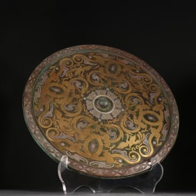 A bronze mirror with a gold and silver dragon and phoenix pattern in the Han Dynasty