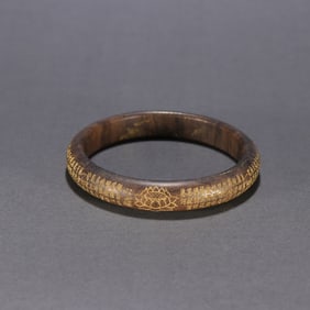 A Qing Dynasty agarwood gilded lotus pattern heart sutra bracelet