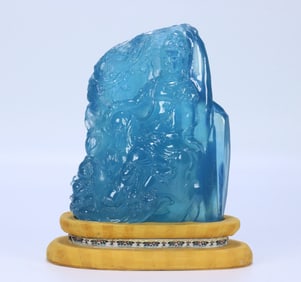 A sculpture of a Qing Dynasty aquamarine boy worshiping Guanyin