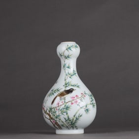 A Qing Dynasty Qianlong pastel flower and bird garlic bottle