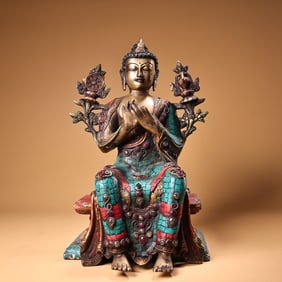 A copper-inlaid gemstone painted Tibetan statue of the Great Sun Buddha