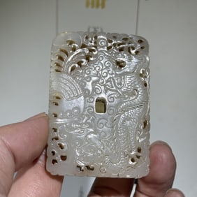 A Qing Dynasty white jade carved dragon and phoenix auspicious box talisman