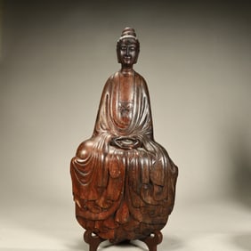 A seated statue of Guanyin carved in agarwood in the Qing Dynasty