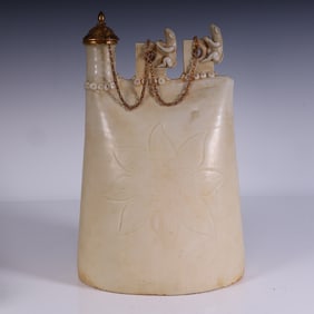 A white glazed carved leather pot