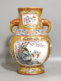 A Qing Dynasty Qianlong gold ground window quail reed goose elephant ear bottle