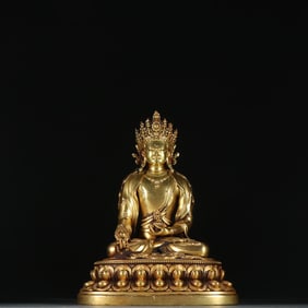 A seated statue of the Ming bronze gilt Medicine Buddha Tathagata