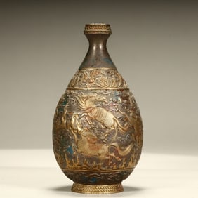 A Qing Dynasty silver-gilt auspicious beast pattern bottle