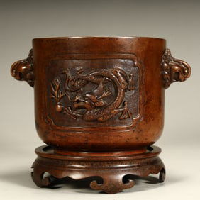 A Qing Dynasty copper dragon pattern lion ear incense burner