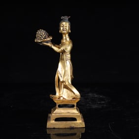 A statue of a bronze gilt maid in the Qing Dynasty offering fruit
