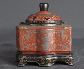 A Qing Dynasty Qianlong bronze coral red ground incense burner