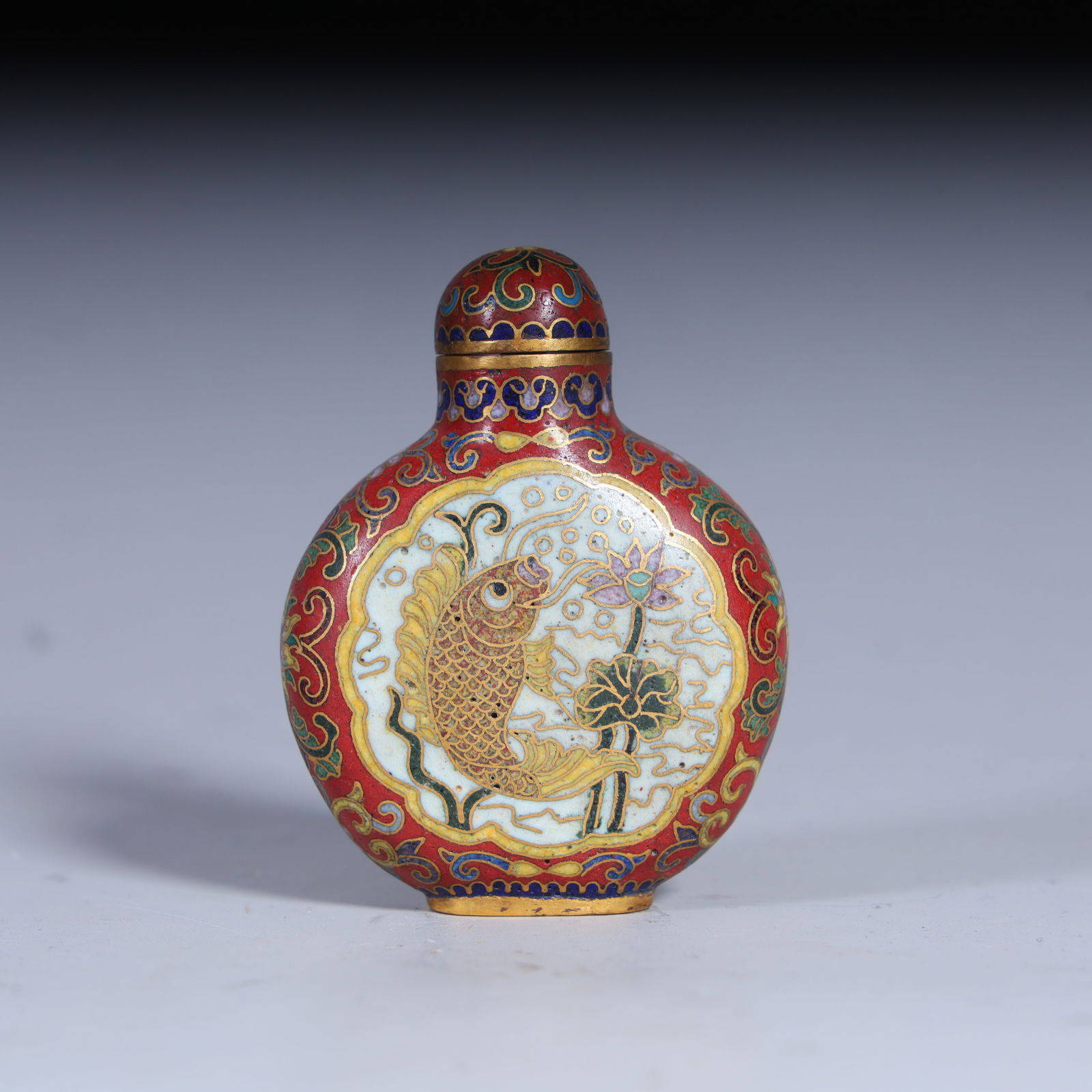 A Qing Dynasty copper tire cloisonné enamel "There are fish every year" snuff bottle (1 of 8)