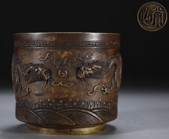 A Ming Dynasty precision cast copper tire double dragon bead pattern cylinder furnace