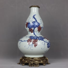 A blue and white glazed red grape gourd bottle with copper edge