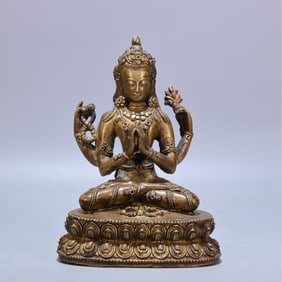 A Qing Dynasty copper-gilt four-armed Guanyin