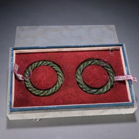 A pair of Qing Dynasty Hetian jade hollow twist bracelets