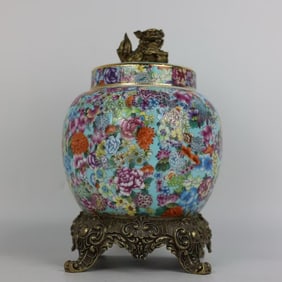 A pastel kaleidoscope of flowers does not fall to the floor and a bronze lion tea jar