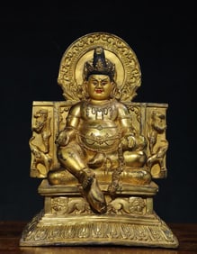 A Qing Dynasty Tibetan tantric bronze gilt painted yellow God of Wealth
