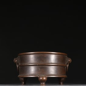 A Ming Dynasty copper-tired beast head ring-ear drum incense burner