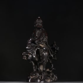 A statue of an Arhat in a rosewood scroll