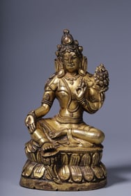 A seated statue of Tara, gilded and green in the middle of the Qing Dynasty
