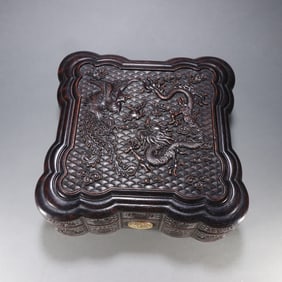 A Qing Dynasty rosewood dragon and phoenix auspicious cover box