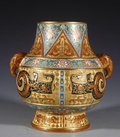 A Qing Dynasty Qianlong carved gold ground elephant ear bottle