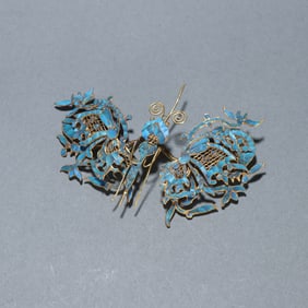 A Qing Dynasty silver-gilt emerald butterfly-shaped hairpin