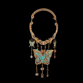 A Qing Dynasty filigree dotted emerald butterfly is listed