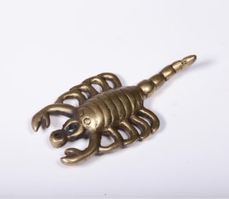 A Qing Dynasty brass scorpion pendant