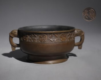 A Qing Dynasty precision cast copper tire dragon head ear bowl furnace