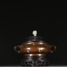 A copper-dotted gold amphora aroma diffuser