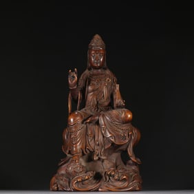 A statue of Guanyin in a clean bottle of Huanghuali