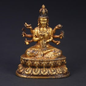 A bronze gilt thousand-handed Guanyin statue