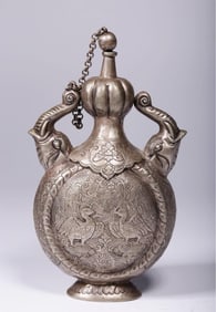 A Qing Dynasty silver carved phoenix patterned elephant ear flat bottle