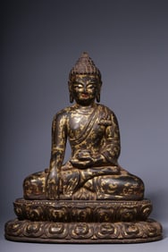 A seated statue of Shakyamuni Buddha carved with gold in wood carving in the Qing Dynasty