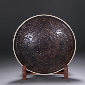 A Song Dynasty black Ding kiln printed dragon cloud pattern cup