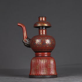 A Qing Dynasty Qianlong bronze coral red gold-painted pattern watering pot