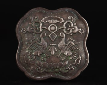 A Tang Dynasty sterling silver compact box is hand-engraved