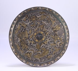 A bronze mirror with a bronze pattern of gold and silver seawater beast and bird pattern in the Han