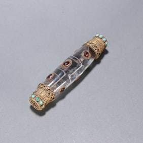 A crystal-clad gold-inlaid jewel offering bead