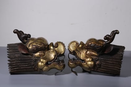 A pair of Qing Dynasty copper gilt dragon head ornaments