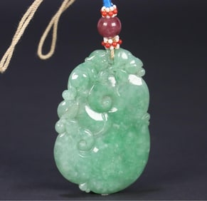 A Qing Dynasty jade spirit monkey presents a rui card