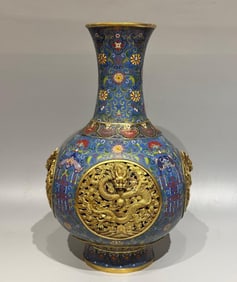 A Qing Dynasty cloisonné enamel four-dragon bottle