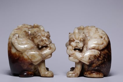 A pair of ancient jade tape biting beast paperweights