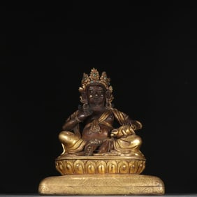 A Qing Dynasty copper gilt yellow God of Wealth shape